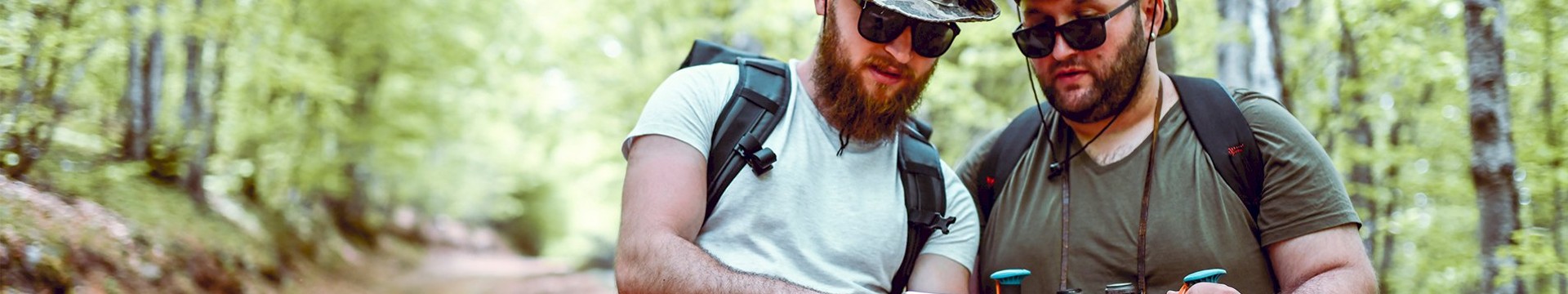 Two men with army print hats on taking on an adventure