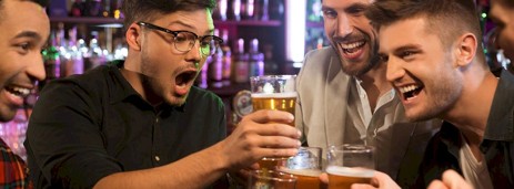 A group of guys enjoying some beers on a boozy stag do night out