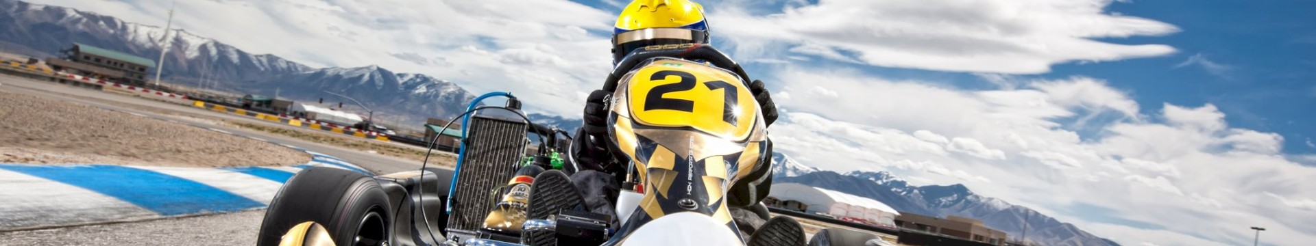 A man on his stag do In a luxury go kart on his outdoor go karting stag do experience