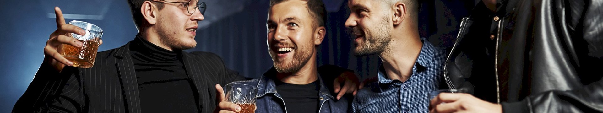 Four men enjoying a beer in a club.