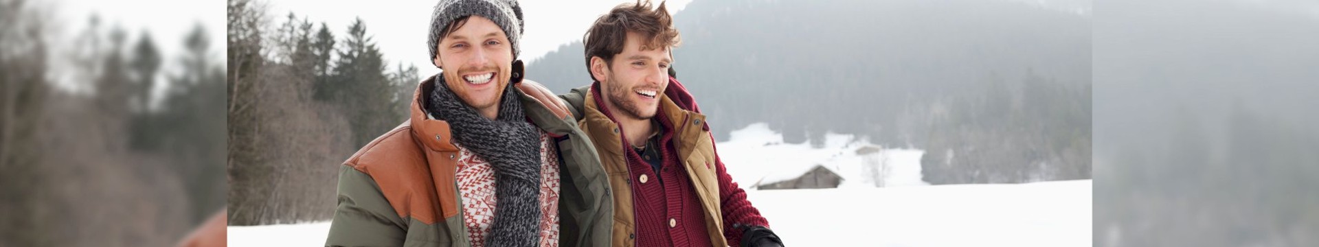 2 men walking together in the snow walking to their next stag do activity