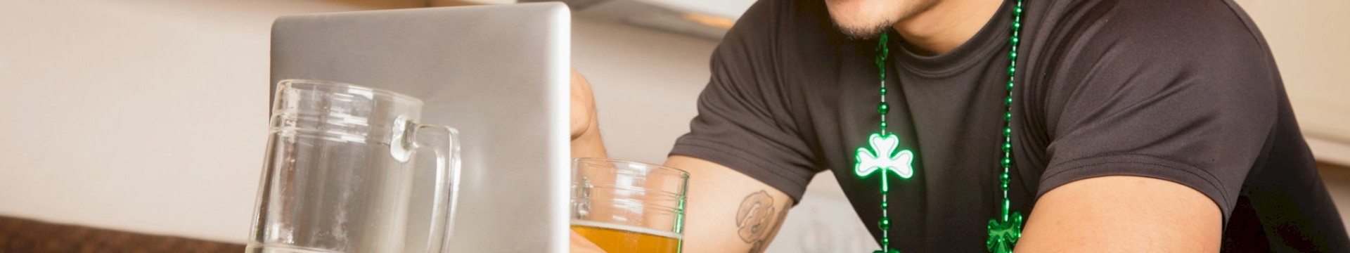 guy at laptop drinking beer