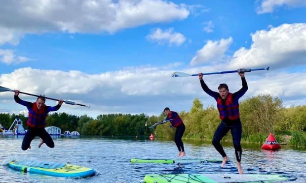 Men Jumping on their paddleboards for a picture on their  best friends stag do
