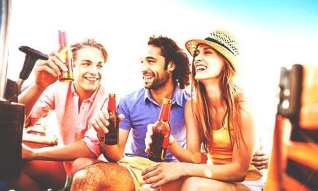 Friends enjoying river cruise with drinks