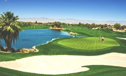 Sunny day at a Golf Course looking out over the greens, sand traps and a lake. Discover La Manga Stag Party ideas below: 