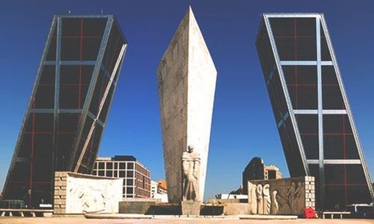Sun shining on the Jose Calvo Sotelo statue and the Gate of Europe. Explore Madrid Stag Party ideas below: