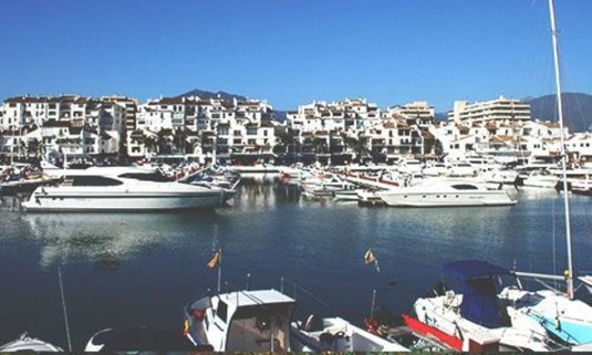 Sun shining over million pound yachts in the Puerto Banus harbour. Discover Puerto Banus Stag Party ideas below: